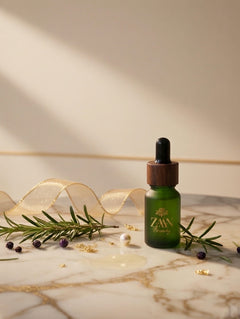 Green skincare serum bottle with dropper on a marble surface with decorative elements