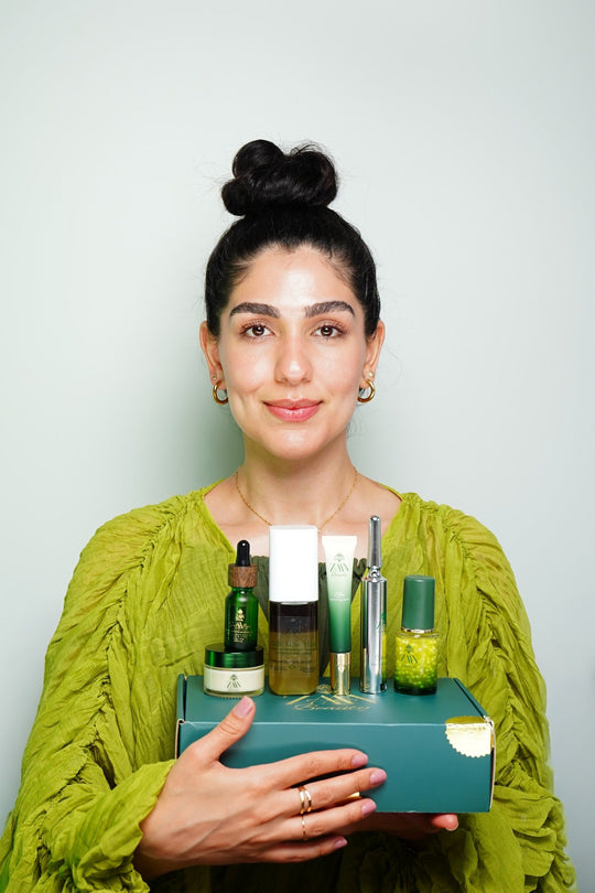 Woman holding the ZAA'N Beauty Persian Botanicals Collection