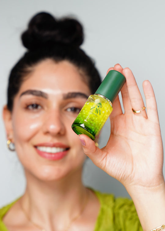 Model holding SOHA Wrinkle Smoothing Serum with saffron pearls