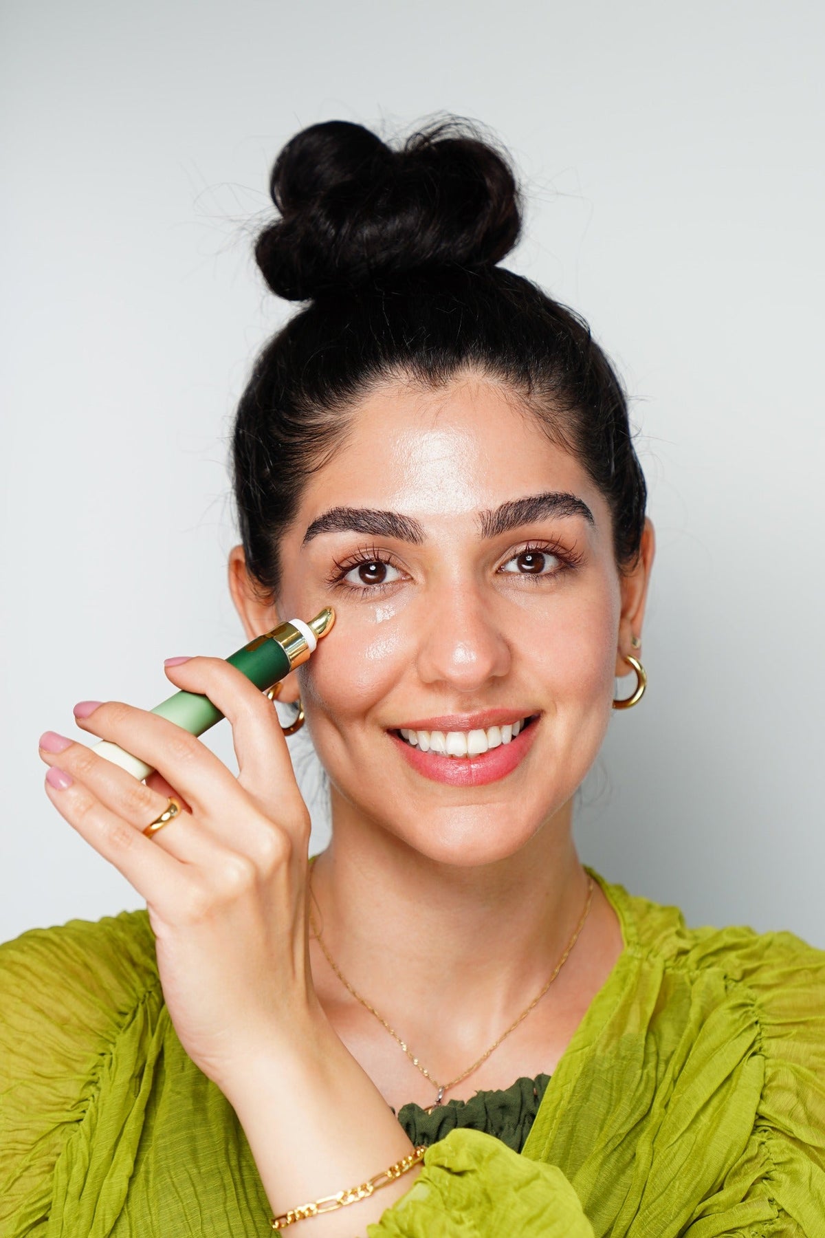 Woman applying ZIBA Firming Eye Serum under the eye