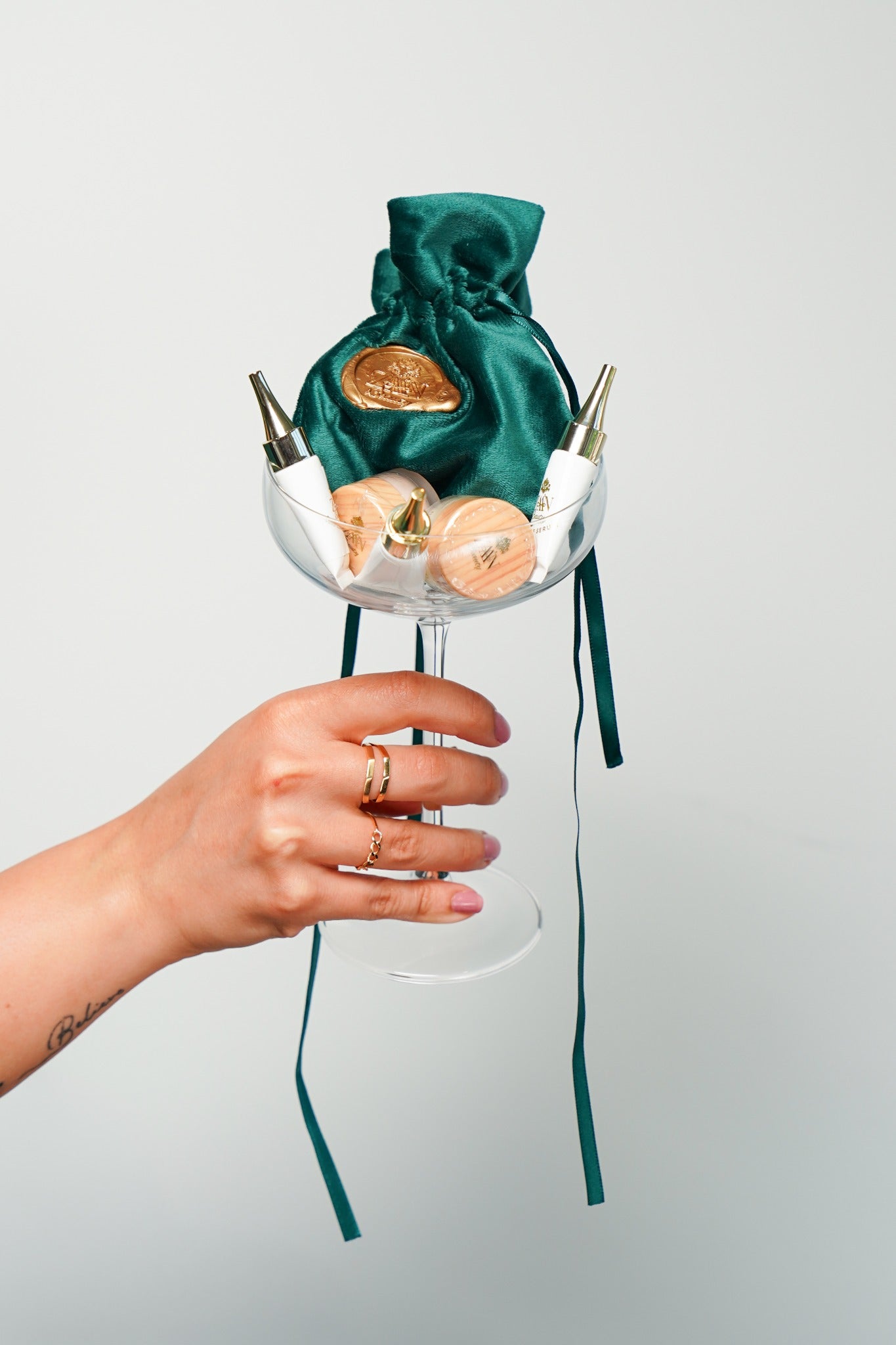 ZAA’N Discovery Pouch miniatures and emerald pouch styled in a clear glass